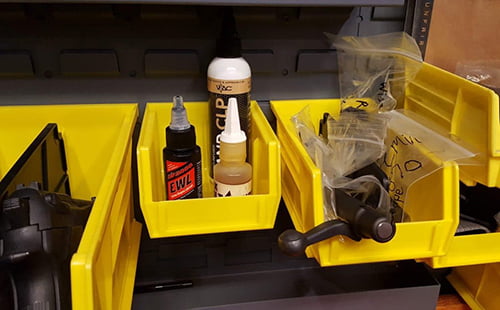 Firearm cleaning supplies in storage bins