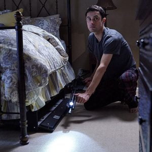 man accessing Fast Box Hidden Gun Safe under a bed