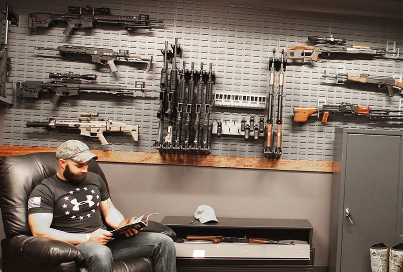 man sitting in gun room